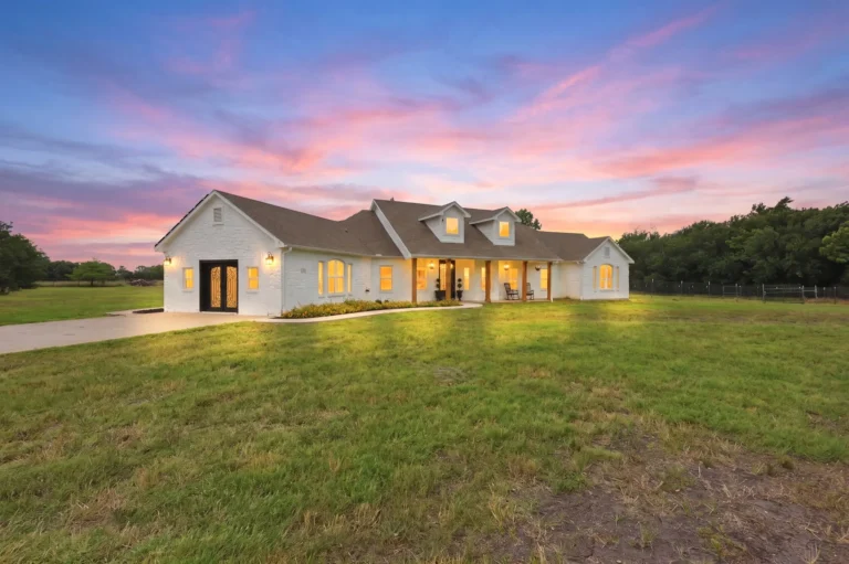 White farmhouse on acreage at sunset — one of my listings in North Texas