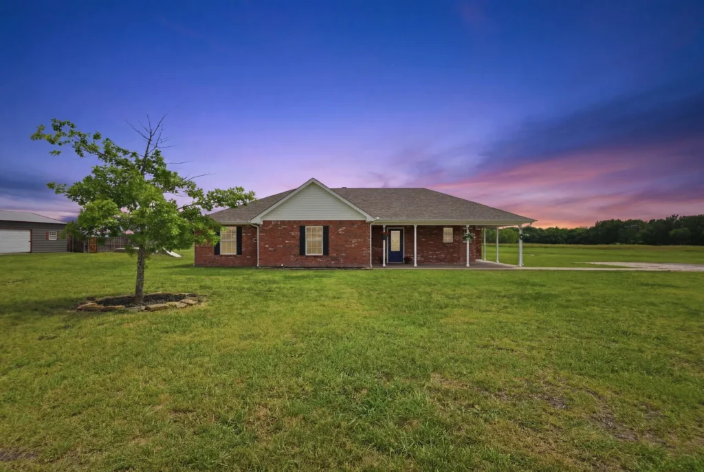 A brick resale home at dusk on an established North Texas street