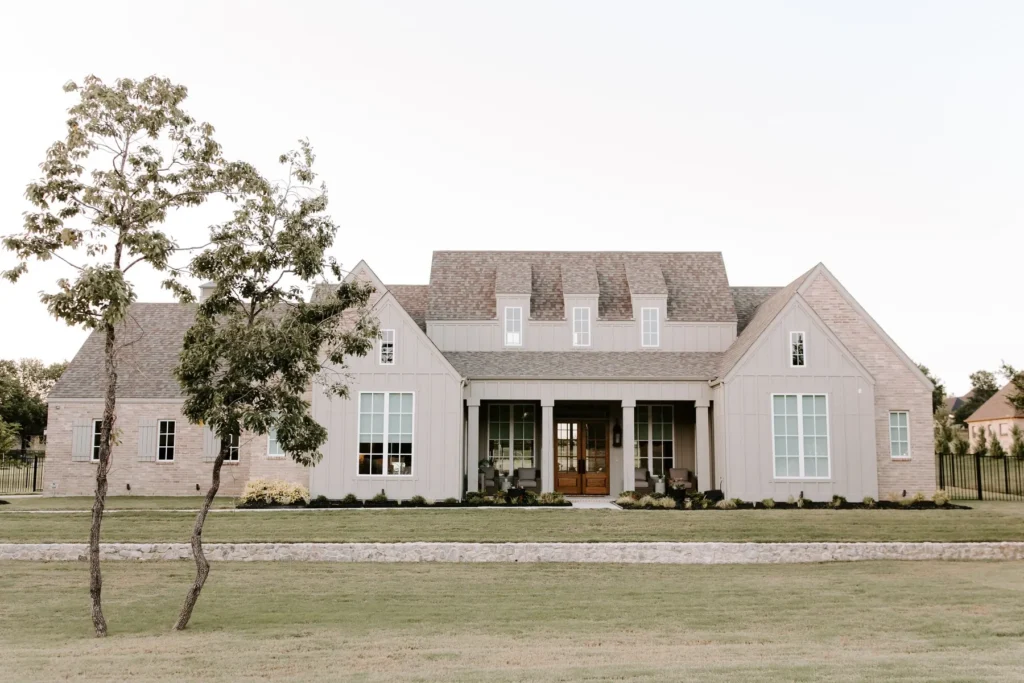 A white brick home on acreage, where land and outbuildings change the value